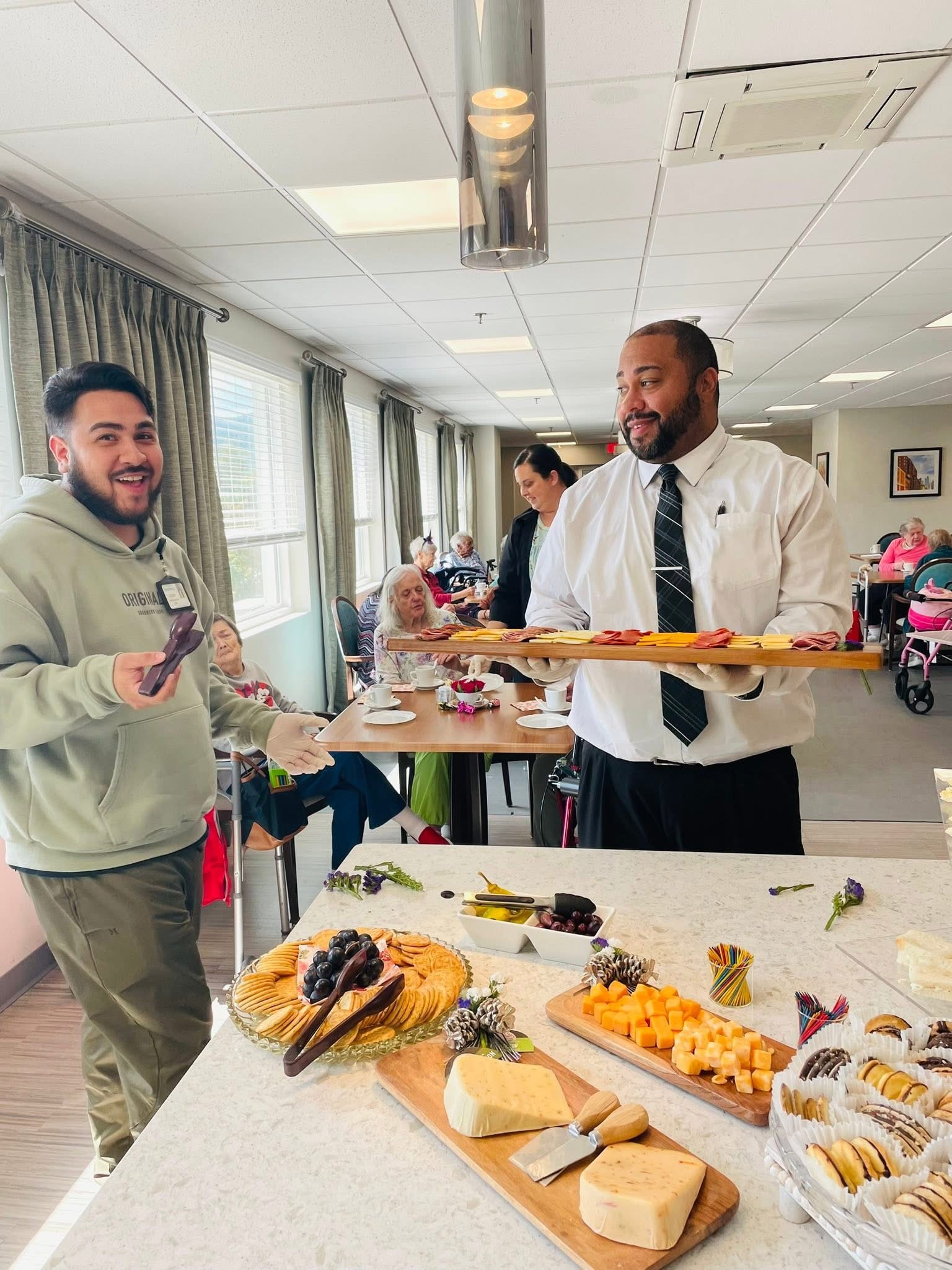 Staff serving residents at dining event