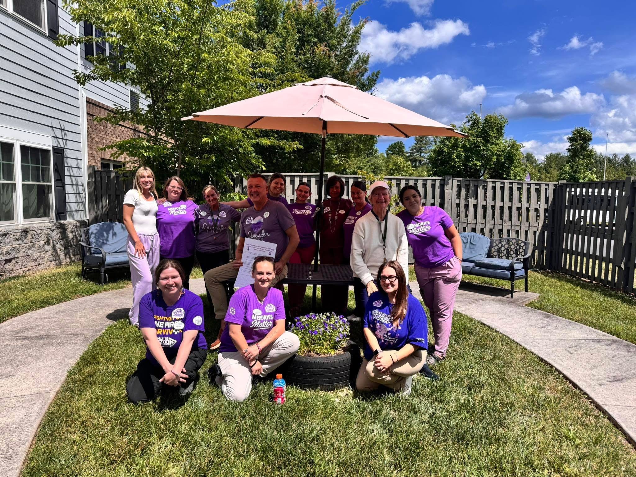 Team in purple shirts at outdoor community event